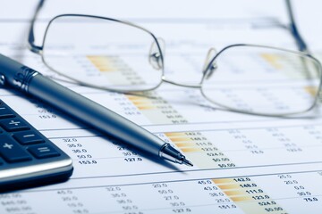 Naklejka na ściany i meble Pen, Eyeglasses and Calculator on Financial Figures
