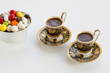 Traditional Turkish Colorful Almond Candies and coffee on white with copy space.