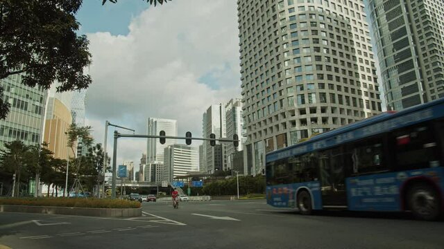 Time lapse of Guangzhou downtown intersection road in early morning on a bright cloudy day.