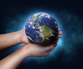 hands holding earth planet in the cosmos. save te earth planet Elements of this image furnished by NASA