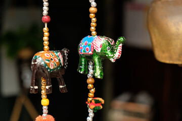 Decorative paper elephants, brown and green - symbols and signs of indian (hindu) and buddhist religions and tradition, low angle view.
