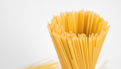 Raw spaghetti on white background.