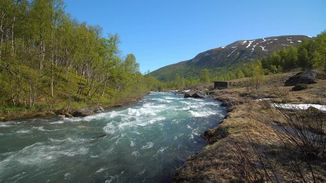 Pan view of rapids in the highlands of Rotsundev, on a sunny, summer day, in the Lyngen alps, North Norway