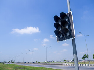 traffic lights against a vibrant blue sky