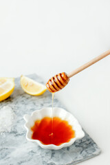 Perfect homemade natural face mask ingredients for bright and healthy skin. Top view of lemon and honey on marble background. Beauty herbal skincare product concept. Copy space