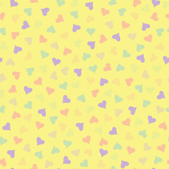 Pastel yellow and multicolor heart theme seamless repeating pattern.