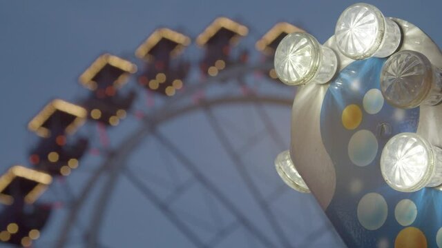 carousel lights near ferris wheel at night