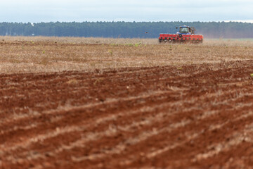 Fototapeta premium plowing machine harvesting on a sunny day