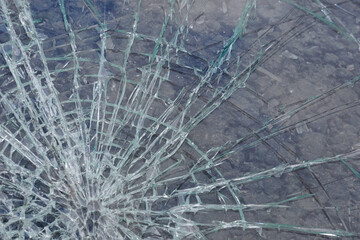 Broken glass with cracks and splinters, background, texture.