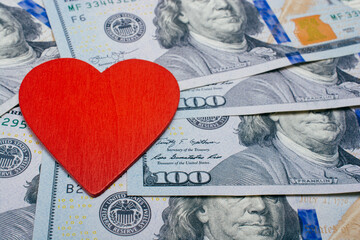 Red heart on a background of dollar  banknotes