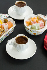 Traditional Turkish Coffee and delicious delights on black background,top view.