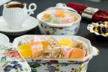Traditional Turkish delicious delights on black background with coffee,close up