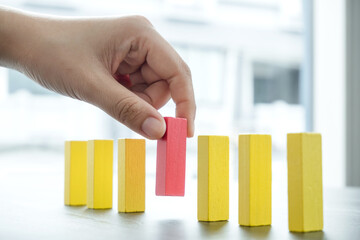 Hands of businesswomen playing wooden block game. Concept Risk of management and strategy plans for business growth and success