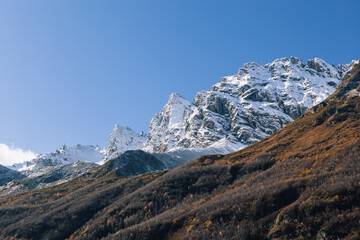 Fototapeta na wymiar Wallpapers of mountains. Big rocks, glaciers and amazing cloud are all beautiful nature of Caucasus. Dombay, Karachay-Cherkessia, Russia.