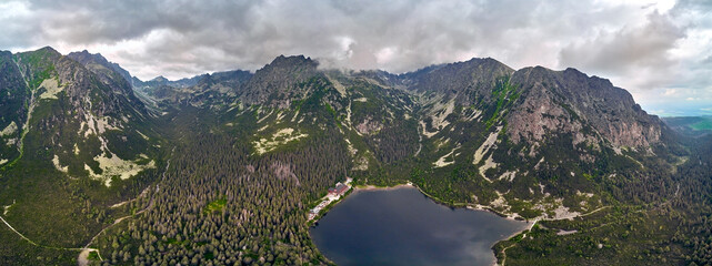 Fototapeta na wymiar Beautiful panoramic view of Popradske pleso (once called Rybie pleso) is a mountain lake of glacial origin located in the High Tatras, northern Slovakia, Europe. Beautiful world.