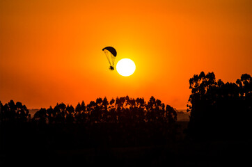 silhouette paraglider of the sun