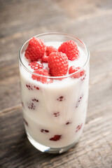 Milk with raspberry in the glass. Selective focus. Shallow depth of field.
