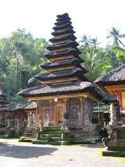 A Balinese Hindu temple set on the foot of a wooded hill. 