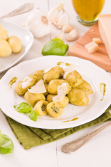 Potato gnocchi stuffed with pesto sauce.	
