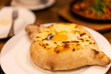 Khachapuri, roast bread with cheese and egg, a traditional georgian dish.