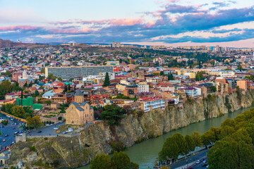 Fototapeta premium Panorama view of city Tbilisi, the capital in Georgia, at sunset.
