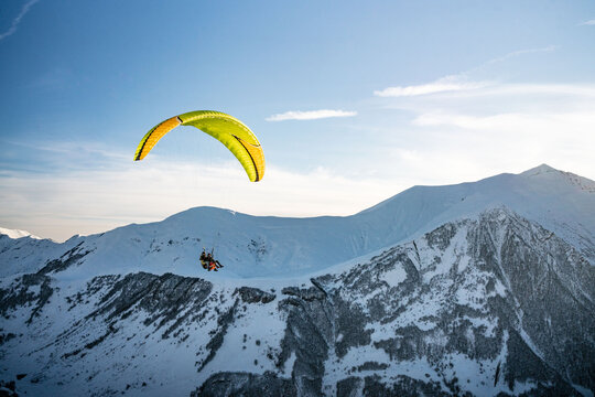 Paraglider on top of Caucasus, in winter time, shot in Georgia.
