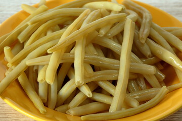 Yellow string beans cooked on plate close up
