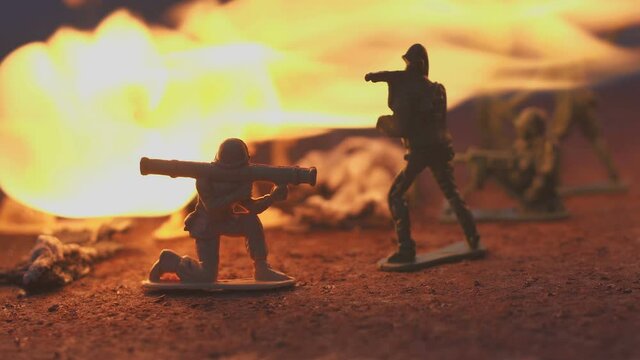 toy soldier in the fire. The model of the battle scene. The concept of the cruelty of war