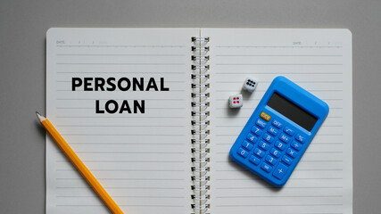 Personal Loan written on a notebook and calculator, business concept.