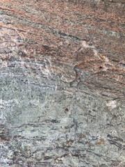 Background texture: the structure of a large stone. Granite boulder close up. Irregularities and cracks in the stone rock. Concept - stone, hardness