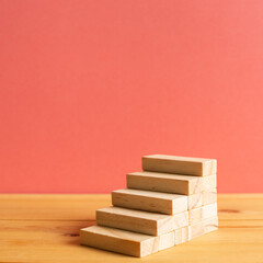 Wood block stairs with pink background. Business development, growth, success concept. with copy space
