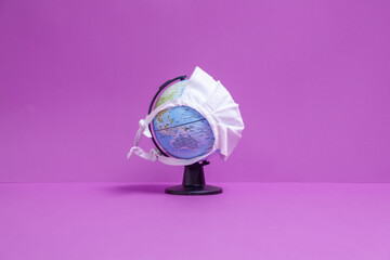 Weltkugel mit weißer Maske mit Sicht auf Australien mit lila Hintergrund 
