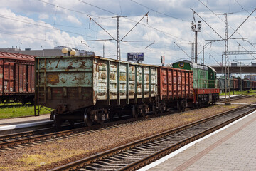 Fototapeta na wymiar Lutsk, Ukraine, July 22, 2020: A locomotive with freight cars at the railway station