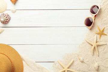 Summer background with beach accessories - straw hat, sunglasses on white wood table background top...
