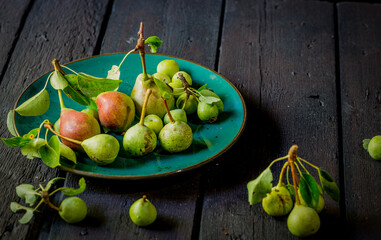 pears on the plate on an aged table