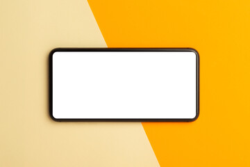 Flat lay, top view of orange office table desk with smartphone blank screen mockup with clipping path. Modern working space.