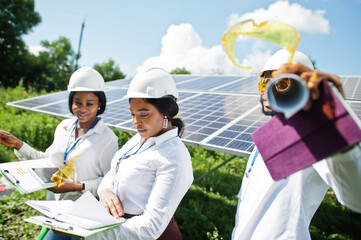 African american technician checks the maintenance of the solar panels. Group of three black...