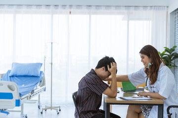 Young Asian female doctor is smiling and touching patient's sholder in hospital room. Medical healtcare concept.