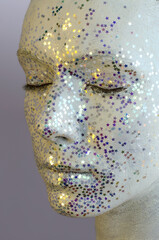 Close-up Portrait of Alternative Model with Creative Make-up. White Makeup, Decorative Stars and Glitter Sparkles all over Woman Face.