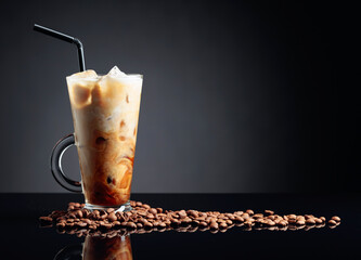 Ice coffee on a black reflective background.