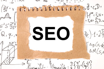 SEO text on white paper surrounded by mathematical formulas. Isolated on white.