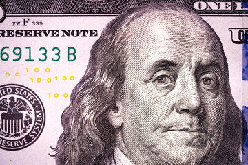Fragment of 100 dollar bill. US dollar background.. Macro shot.