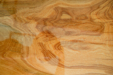 The background image of the plank made of varnish, giving a clear reflection.