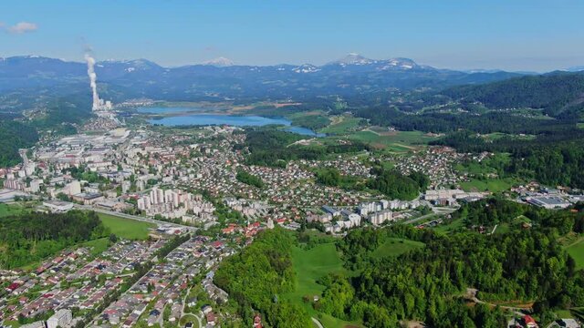 Velenje Lake with coal power station in background. Aerial backwards