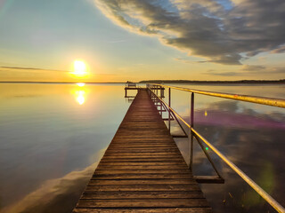 beautiful boardwalk during sunrise at lake Müritz