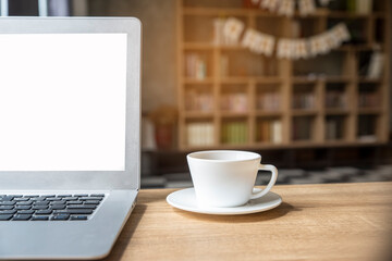 Desk for student concept. Laptop for study for exam and place on School table for student work online at home. Computer and cup of coffee place on wooden desk in library.
