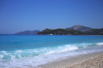 The blue stormy sea off the coast of Oludeniz in Turkey is one of the most beautiful and popular tourist destinations in Turkey.