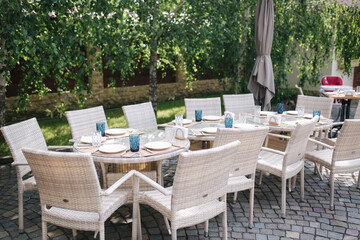 Served table set at suumer terrace. Cutlery in cafe. Green background