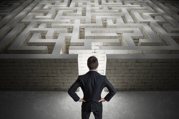 Businessman is searching exit path in maze. Strategy and decision concept.