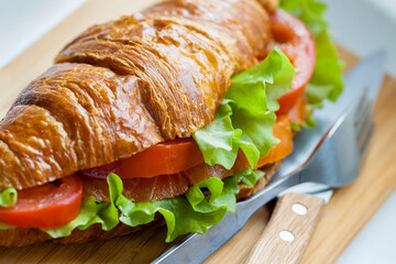 Smoked salmon croissants with salad, tomato